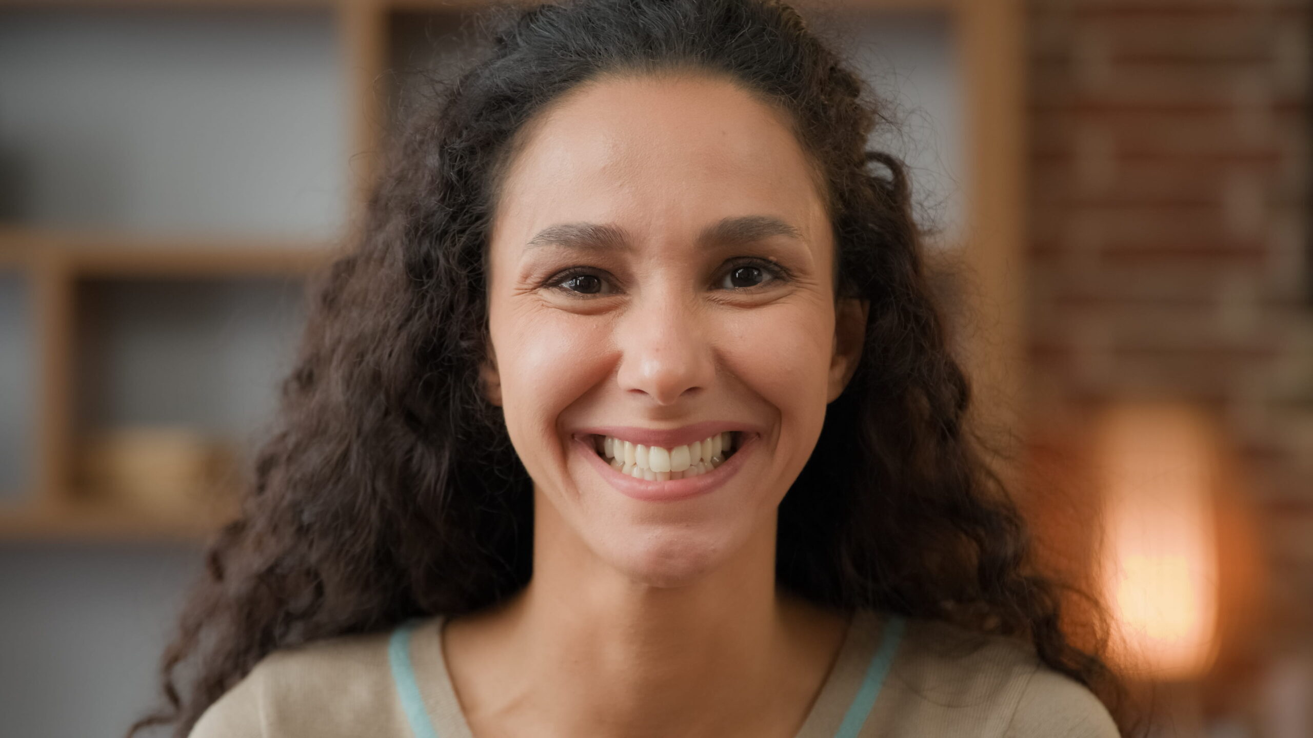 Woman with a bright, healthy smile in a dental practice setting.